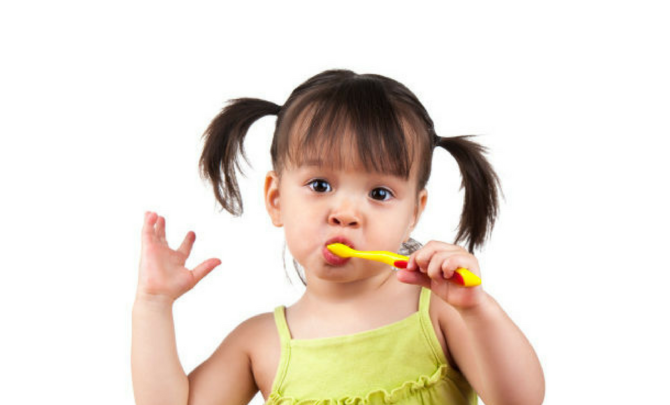 toddler brushing baby teeth