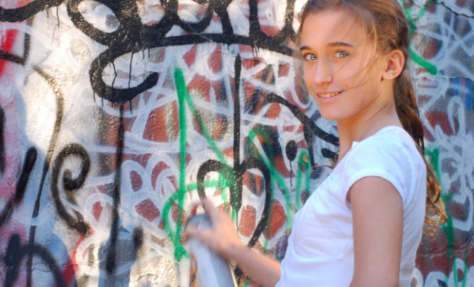 girl-spray-painting-graffiti